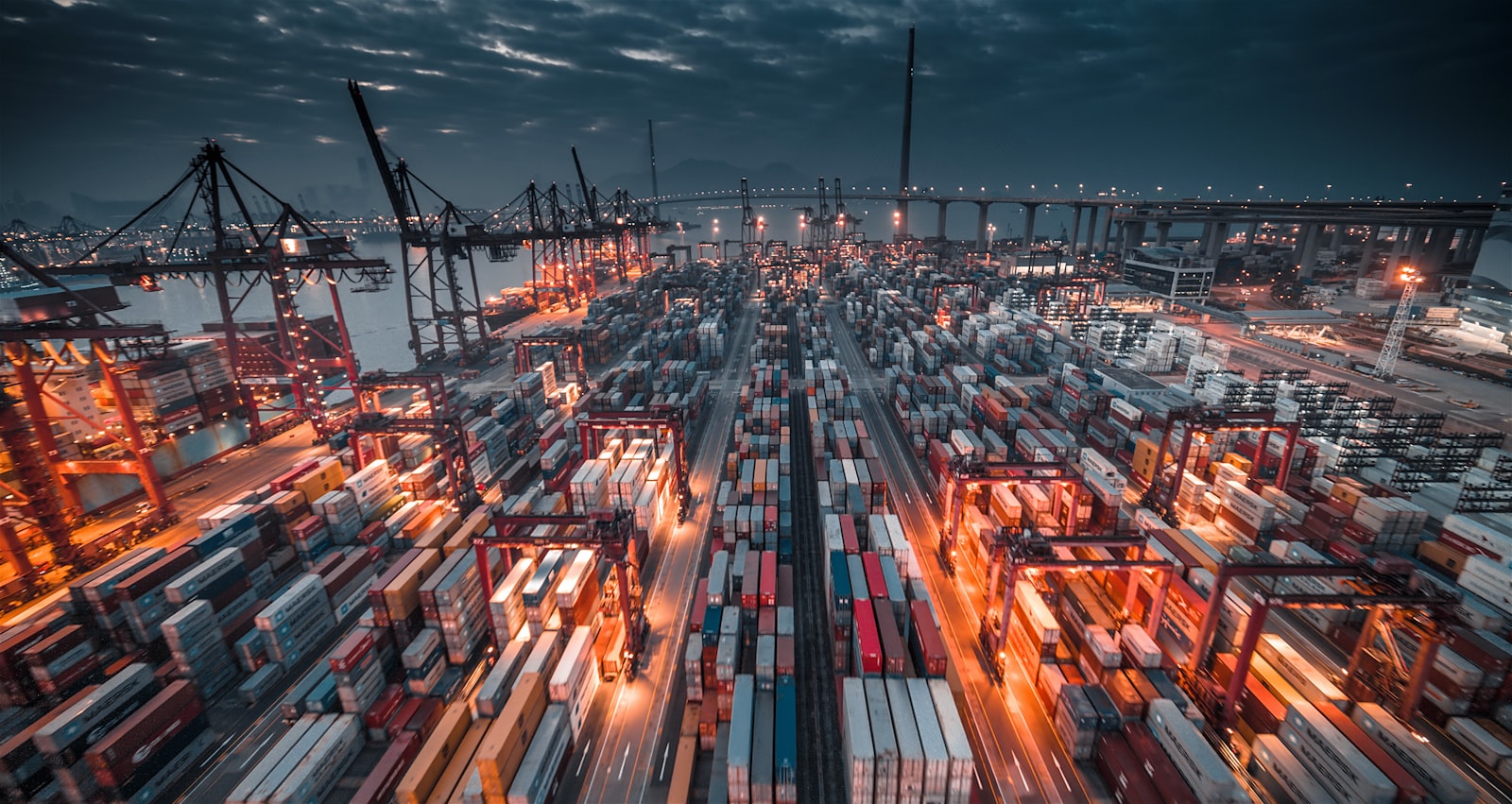 Container cranes over a port at dusk